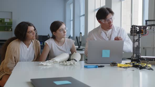 Teacher Explains to the Students How the 3D Machine Should Be Connected