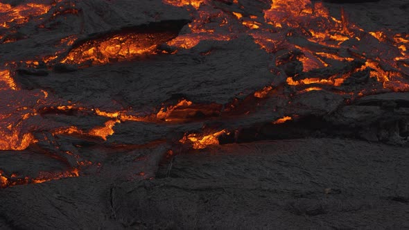 Incredible view of masses of earth moving as river stream of glowing lava flows