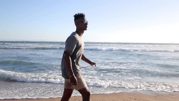 Mature Man Walking At The Beach