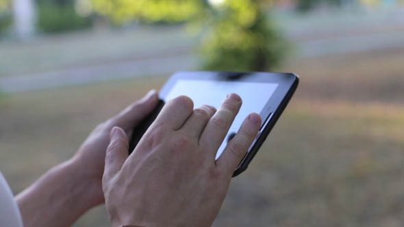 Man Uses a Tablet