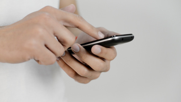 Young Man Browsing on Smart Phone