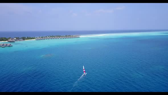 Aerial above sky of relaxing resort beach holiday by blue water with bright sand background of a day