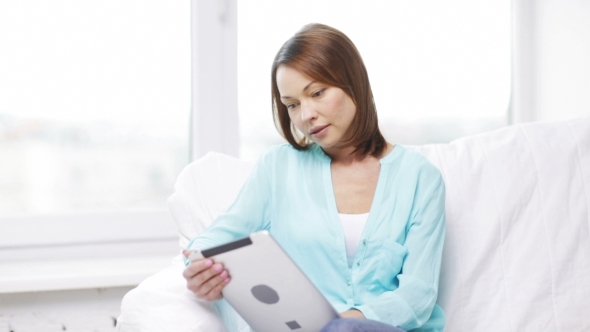 Woman With Tablet Pc Computer At Home