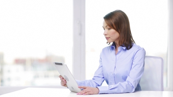 Businesswoman With Tablet Pc In Office