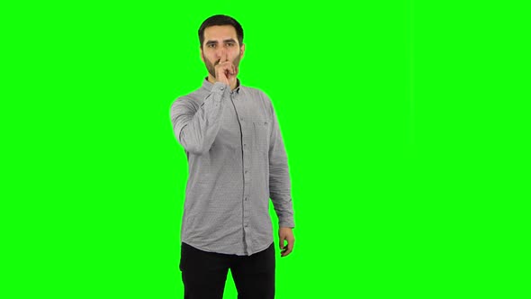 Brunette Guy Looking Straight and Making Sign I Am Cool. Green Screen