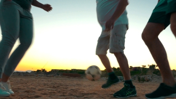 Active Family Playing Football On The Beach alt