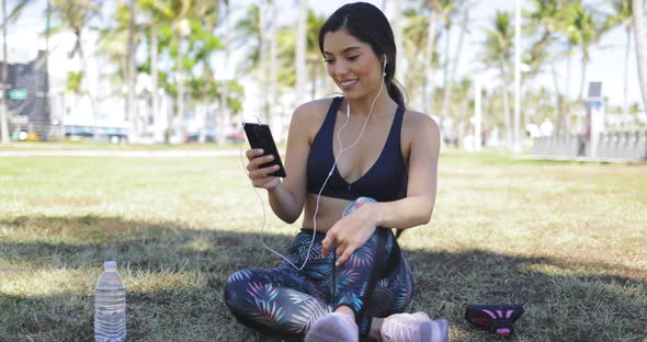 Pretty Girl with Phone on Workout in Park