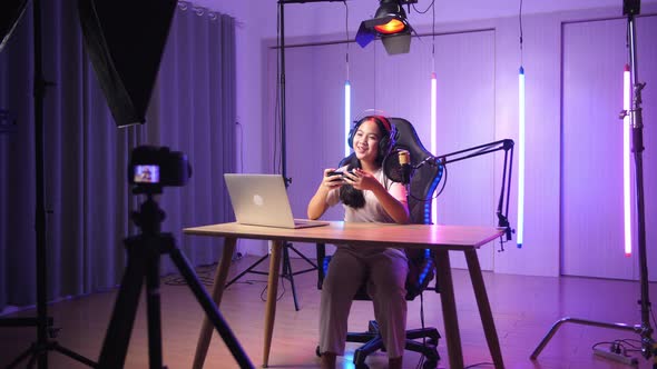 Asian Kid Girl Hold Phone And Talking To Camera While Live Stream, Professional Light Equipment