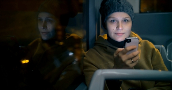 Young Woman Typing Sms During Bus Ride