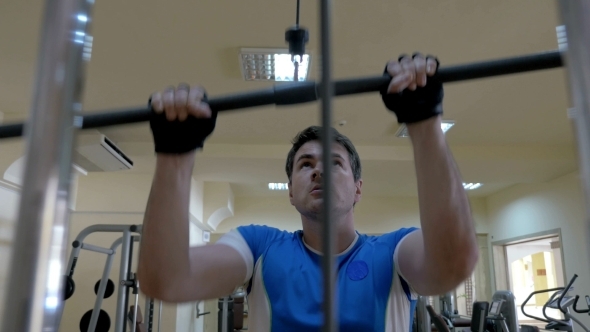 Young Man Working On Pull Down Machine