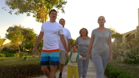Family Walk Outdoor On Summer Resort