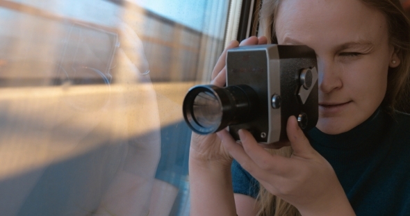 Woman Using Retro Video Camera To Shoot The Way
