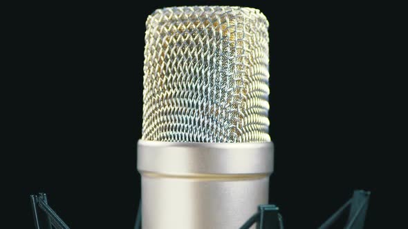 Studio Microphone with Spider Rotates on a Black Background