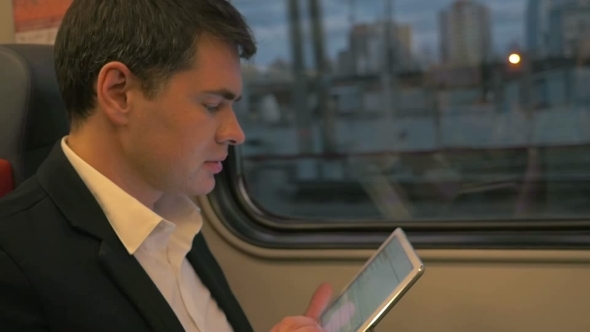 Man With Tablet Computer On Business Trip