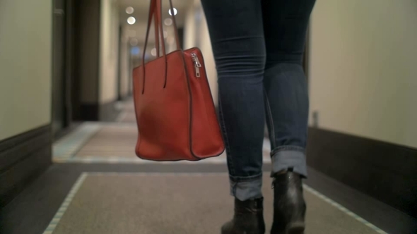 Woman With Bag Walking In Hotel Hall