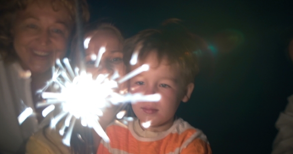 Parents, Child And Sparkler At Night