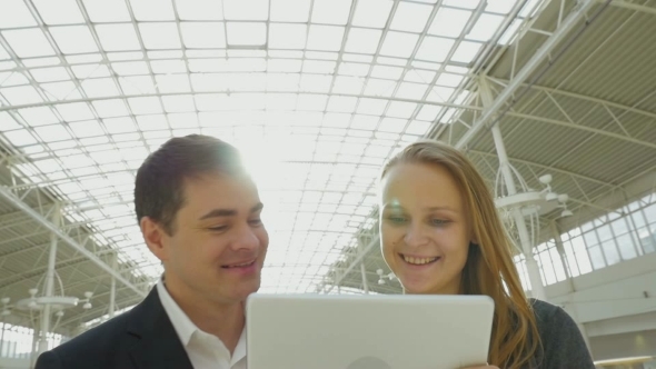Young Happy Businesspeople Using Pad In Office alt