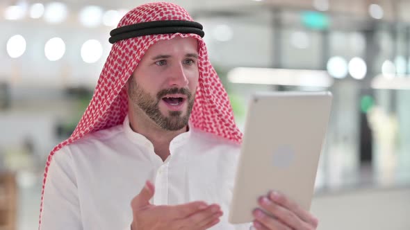 Excited Businessman Celebrating Success on Tablet