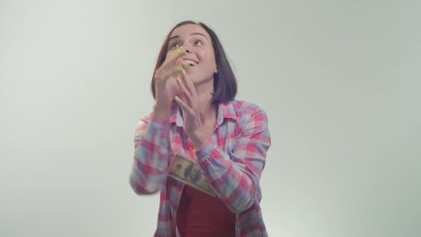 Woman trying to catch up dollar bills