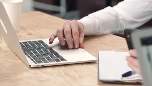 Closeup of Man Hands Typing at Laptop in the Business Workplace Office. Gesturing. Concept Working