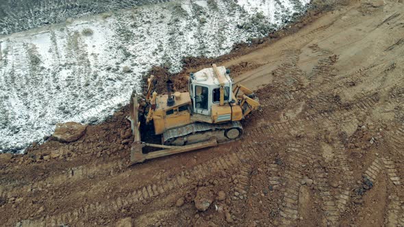 Working Tractor Moves Sand and Stones at a Quarry.