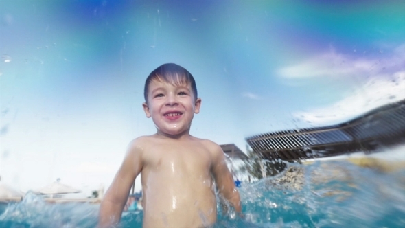 Boy Having Fun In The Pool On Resort