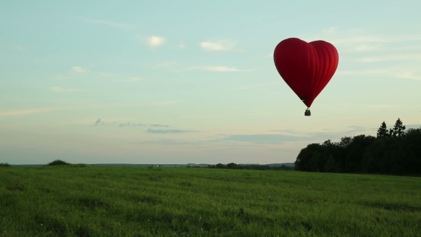 Hot Air Balloons Flying Over Field In Countryside