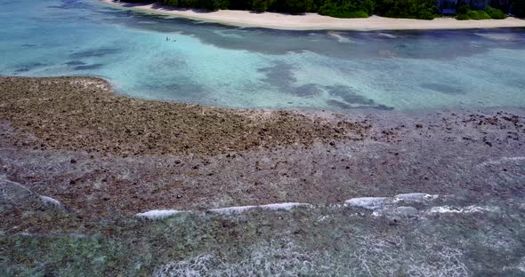 Tropical fly over island view of a sunshine white sandy paradise beach and blue water background