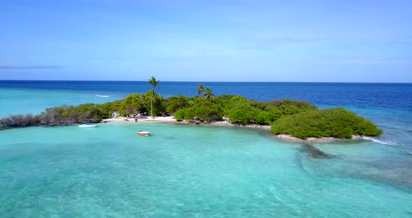 Natural aerial island view of a paradise sunny white sand beach and blue water background in colourf