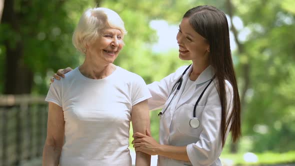 Doctor Accompanying Mature Patient During Walking Outdoor, Medicare, Insurance