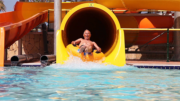 Senior Have Fun On Water Slide