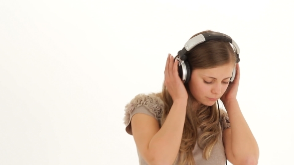Romantic Young Girl In Earphones Listening To