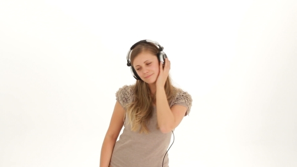 Young Pretty Lady In Earphones Listening To Music