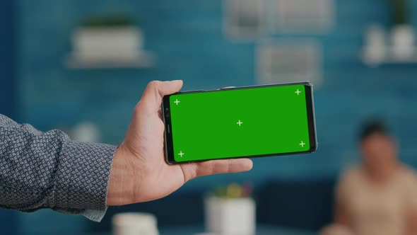 Front View of Horizontal Isolated Mock Up Green Screen Chroma Key Display of Modern Smartphone