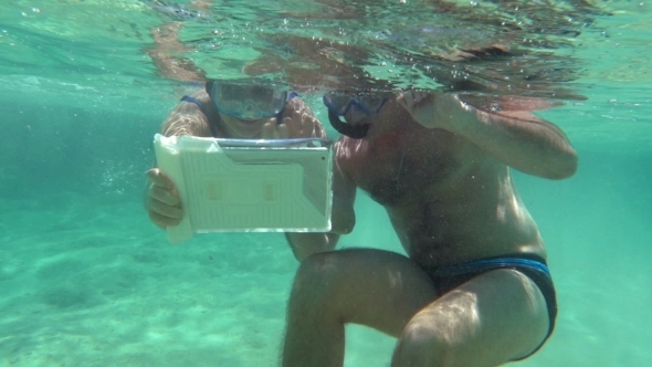 Young Couple Making Selfie Underwater alt