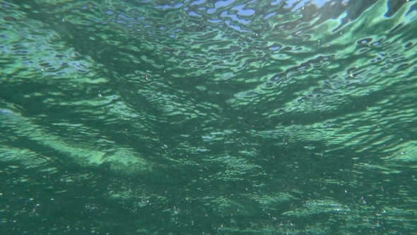 Water Scene With Ripples And Sun Reflection