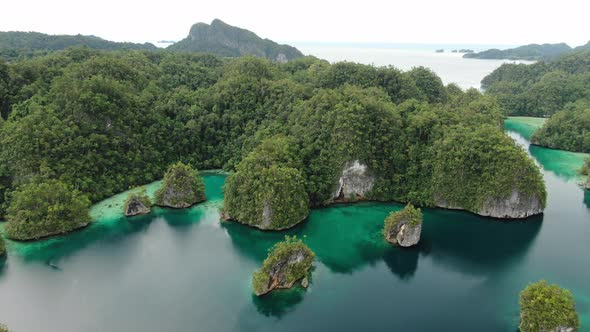 Aerial View Of Triton Bay With Turquoise Sea And Green Tropical Trees In Kaimana Islands