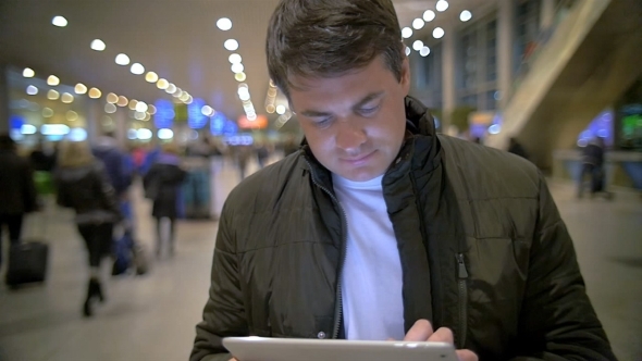 Man Using Electronic Tablet At The Station alt