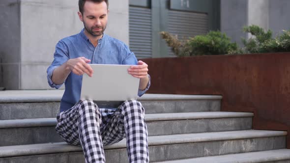 Man Leaving After Sitting on Stairs and Working on Laptop