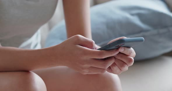 Woman use of mobile phone at home