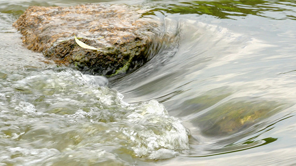 Fast Flowing River With Stones In The Water