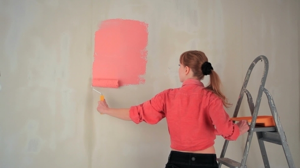 Woman Paints The Wall On The Stairs