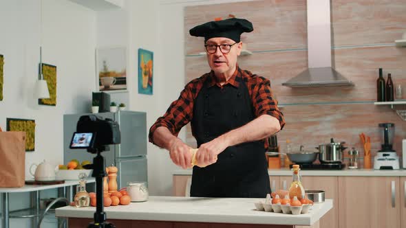 Grandfather Recording Food Video in Kitchen