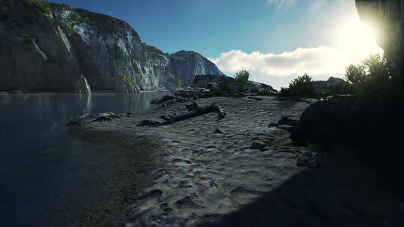 Beach Coast of the Norwegian Sea with Mountains and Cliffs on Sunny Day