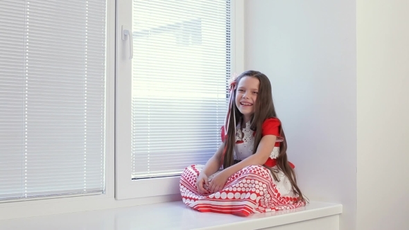 Girl 6-7 Years Sitting In The Window And Watch