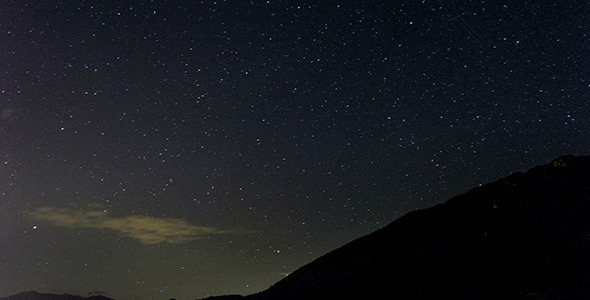 Stars Moving In Night Sky Over Mountain Ridge