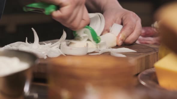 Chef Cuts Daikon Radish Slices on Cutting Board