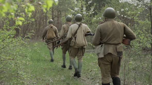 Russian Soviet Infantry Red Army Soldiers Of World War II Marching Walking Along Forest Road In