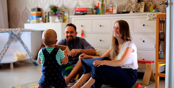 Small Child Walks to His Parents in the Nursery