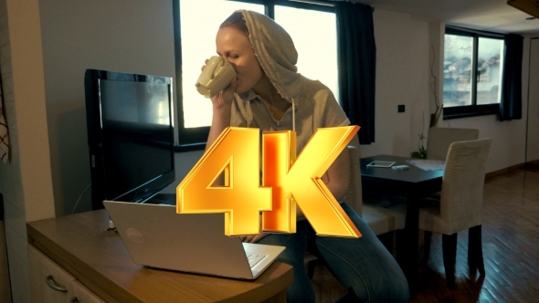 Woman At Home Chatting On Laptop And Drinking Tea alt